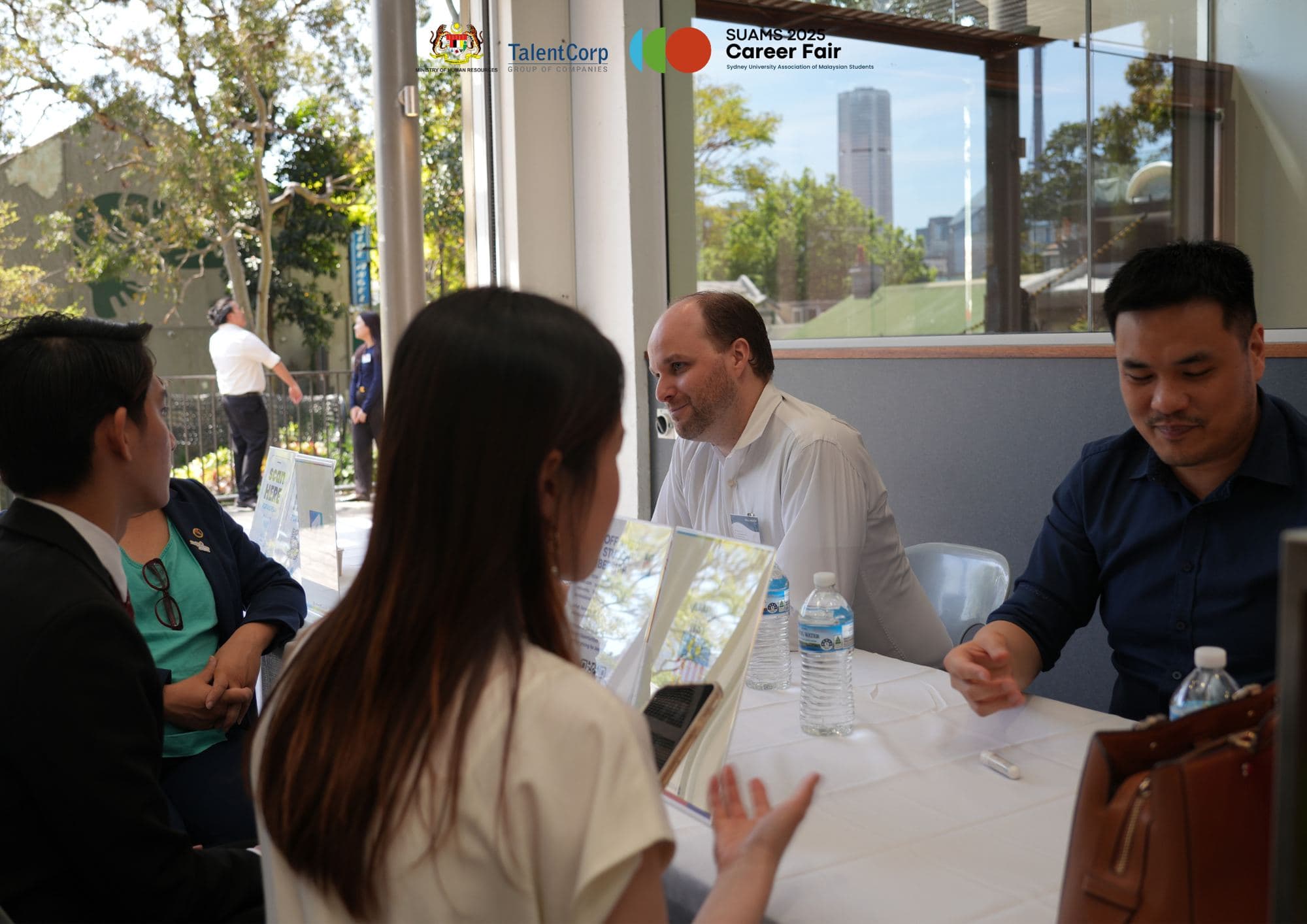 Students and employer representatives in conversation at SUAMS Career Fair 2025